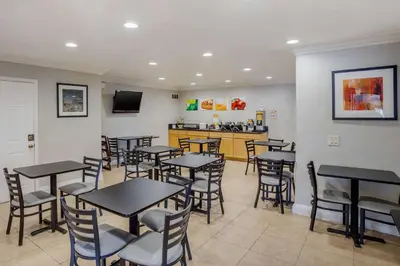 a restaurant with tables and chairs and a kitchen at Quality Inn & Suites El Cajon San Diego East in El Cajon