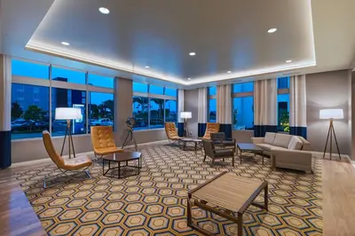 a large lobby with chairs and tables and windows at TownePlace Suites by Marriott San Diego Airport/Liberty Station in San Diego