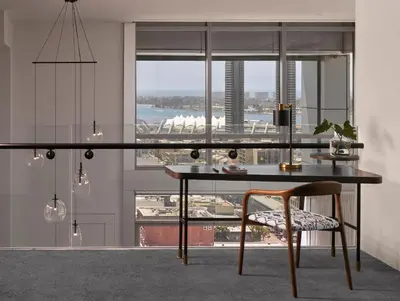 a dining room with a glass table and a chair at Alma San Diego Downtown, a Tribute Portfolio Hotel in San Diego