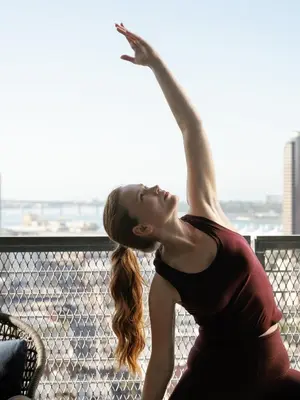 a woman is standing with her arm in the air at Alma San Diego Downtown, a Tribute Portfolio Hotel in San Diego