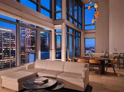 a living room with a couch and a table at Alma San Diego Downtown, a Tribute Portfolio Hotel in San Diego