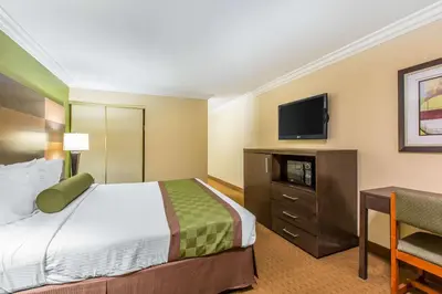 a hotel room with a bed and a flat screen tv at Rodeway Inn & Suites Canyon Lake-Menifee West in Canyon Lake