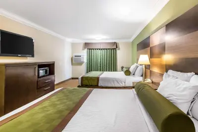 a hotel room with a bed and a couch at Rodeway Inn & Suites Canyon Lake-Menifee West in Canyon Lake
