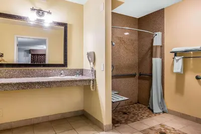 a bathroom with a shower and a sink at Rodeway Inn & Suites Canyon Lake-Menifee West in Canyon Lake
