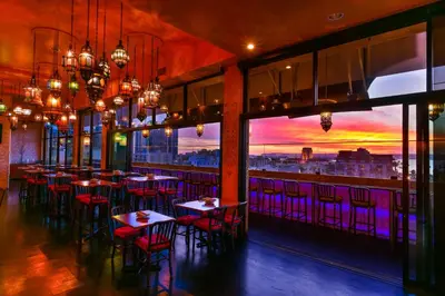 a restaurant with tables and chairs and a view of the city at Porto Vista Hotel In Little Italy in San Diego