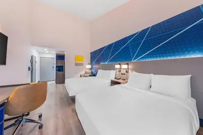 a hotel room with two beds and a desk at Comfort Inn & Suites Irvine Spectrum in Lake Forest