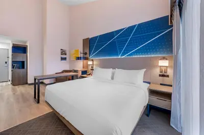 a bedroom with a large white bed and a desk at Comfort Inn & Suites Irvine Spectrum in Lake Forest