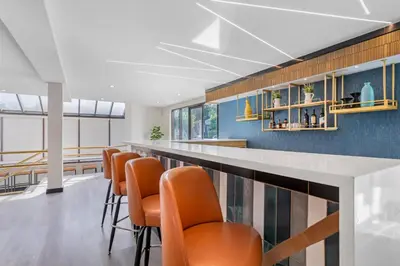 a bar with orange chairs in a room at Comfort Inn & Suites Irvine Spectrum in Lake Forest