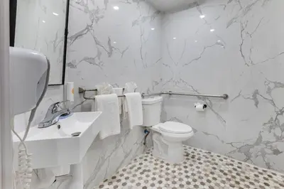a white bathroom with a toilet and a sink at Comfort Inn & Suites Irvine Spectrum in Lake Forest