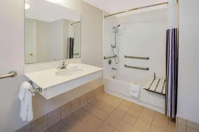 a bathroom with a sink and a tub and a shower at La Quinta Inn & Suites by Wyndham Irvine Spectrum in Irvine