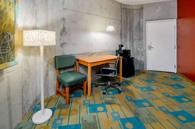 a room with a table and two chairs and a lamp at La Quinta Inn & Suites by Wyndham Irvine Spectrum in Irvine