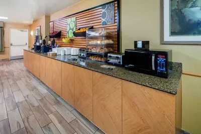 a kitchen with a counter with a microwave at La Quinta Inn & Suites by Wyndham Irvine Spectrum in Irvine