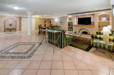 a living room with a couch and a fireplace at La Quinta Inn & Suites by Wyndham Irvine Spectrum in Irvine