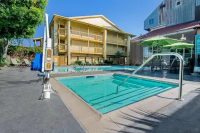 a swimming pool in front of a building at La Quinta Inn & Suites by Wyndham Irvine Spectrum in Irvine