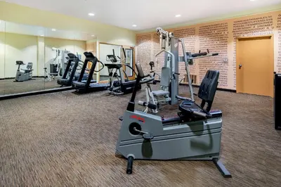 a gym with treadmills and elliptical machines at La Quinta Inn & Suites by Wyndham Irvine Spectrum in Irvine