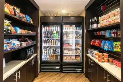 a refrigerator with its doors open in a store at Best Western Inn & Suites San Diego Zoo -SeaWorld Area in San Diego