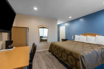 a hotel room with a bed and a television at Rodeway Inn Escondido Downtown in Escondido