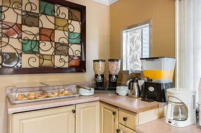 a kitchen with a counter with a blender and a window at Rodeway Inn Escondido Downtown in Escondido