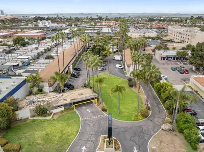 an aerial view of a city with a parking lot at Hotel Palmeras Chula Vista in Chula Vista