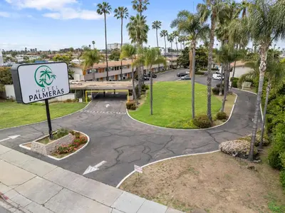 a view of a parking lot at a park palmetto apartments at Hotel Palmeras Chula Vista in Chula Vista