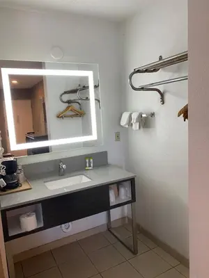 a bathroom with a sink and a mirror at Hotel Palmeras Chula Vista in Chula Vista