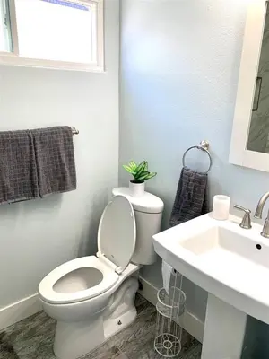 a bathroom with a white toilet and a sink at 125-Fun In The Sun Penthouse in San Diego