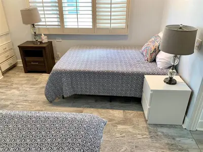 a bedroom with two beds and a lamp on a night stand at 125-Fun In The Sun Penthouse in San Diego