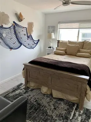 a bedroom with a large bed and a window at 120-Oceanfront Penthouse 5 in San Diego
