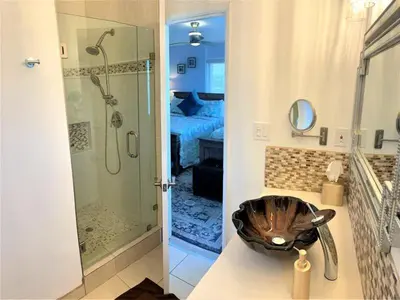 a bathroom with a shower and a sink with a bowl at 120-Oceanfront Penthouse 5 in San Diego