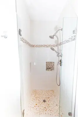 a shower with a glass door in a bathroom at 120-Oceanfront Penthouse 5 in San Diego