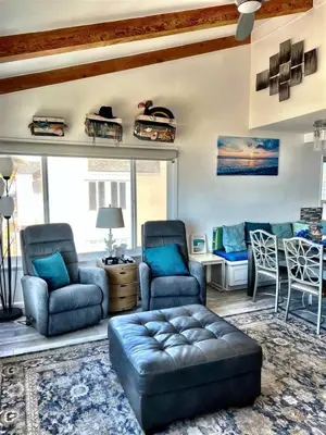 a living room with a couch and chairs and a table at 120-Oceanfront Penthouse 5 in San Diego