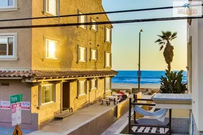 a yellow building with a view of the beach at 200-Surf Stars Penthouse in San Diego