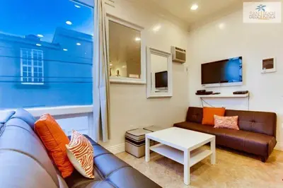 a living room with a couch and a table at 200-Surf Stars Penthouse in San Diego