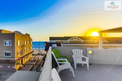 a balcony with two chairs and a view of the ocean at 200-Surf Stars Penthouse in San Diego