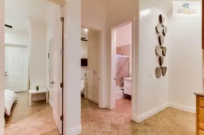 a large white room with a bedroom and a bathroom at 200-Surf Stars Penthouse in San Diego