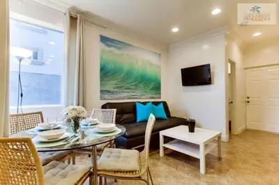 a living room with a table and a couch at 201-Surf Stars Studio in San Diego