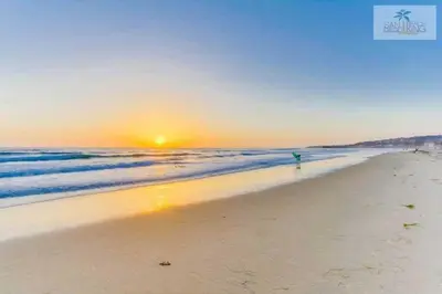a person walking on the beach at sunset at 201-Surf Stars Studio in San Diego