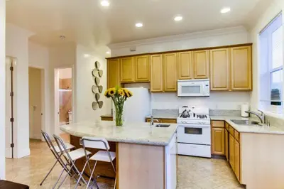 a kitchen with a vase of flowers on a counter at 199-Surf Stars Combo in San Diego