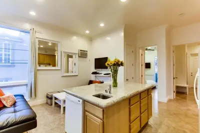 a kitchen with a sink and a living room at 199-Surf Stars Combo in San Diego