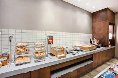 a bakery counter with a bunch of pastries at SpringHill Suites by Marriott Escondido Downtown in Escondido