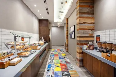 a bakery with a long counter with pastries at SpringHill Suites by Marriott Escondido Downtown in Escondido