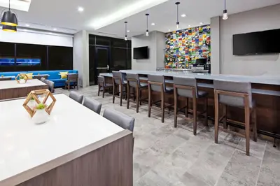 a bar in a restaurant with chairs and a counter at SpringHill Suites by Marriott Escondido Downtown in Escondido