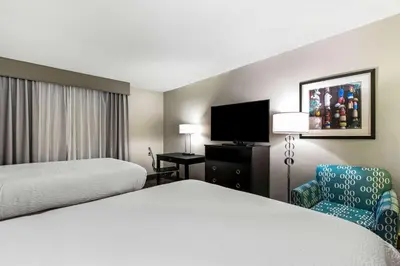 a hotel room with two beds and a tv at La Quinta by Wyndham San Diego Mission Bay in San Diego