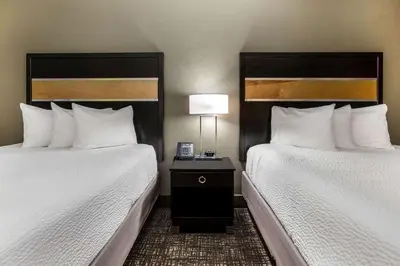a hotel room with two beds and a table with a lamp at La Quinta by Wyndham San Diego Mission Bay in San Diego