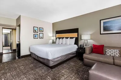 a hotel room with a bed and a couch at La Quinta by Wyndham San Diego Mission Bay in San Diego