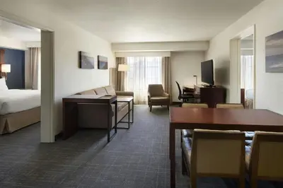 a hotel room with a bed and a living room at Residence Inn San Diego Del Mar in San Diego