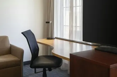 a room with a desk with a chair and a television at Residence Inn San Diego Del Mar in San Diego