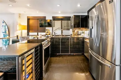 a kitchen with a stainless steel refrigerator at 105-Sleekretreat in San Diego