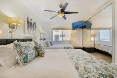 a bedroom with two beds and a ceiling fan at 101-Luxury1 in San Diego