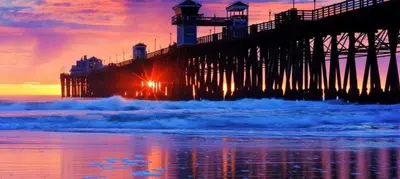 a pier on the beach at sunset with the ocean at 101-Luxury1 in San Diego